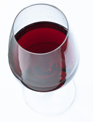 Wine glass with red wine on a table, top view
