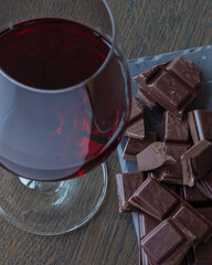 Red wine and chocolates on a wooden table