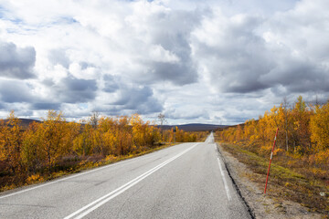Scenic asphalt road through the beautiful view of mountain in Lapland,Kasivarsi. Concept of roadtrip, travel, vacation, adventure.