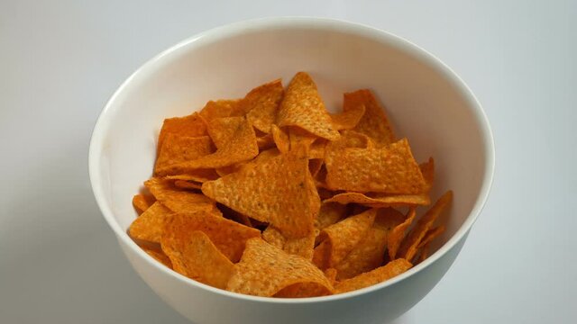 Man Grabs Handfuls Of Chips From Bowl