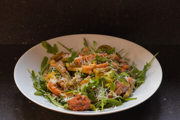 Rucola with  caserecce tricolor, pasta with broccoli, red pesto & grana padano
