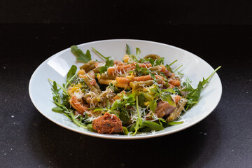 Rucola with  caserecce tricolor, pasta with broccoli, red pesto & grana padano