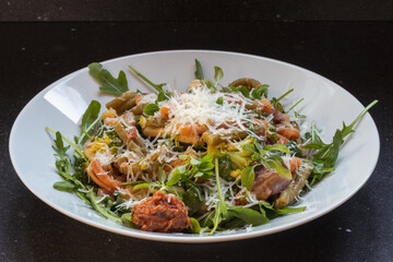 Rucola with  caserecce tricolor, pasta with broccoli, red pesto & grana padano