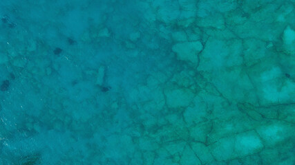 Aerial top down view photo of azure blue ocean. Beautiful bright green color of sea reef shallow water.