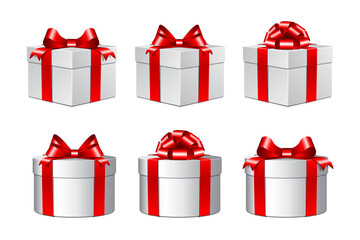 Three white gift boxes with a red bows.