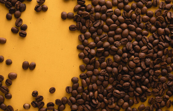 Coffee beans isolated on yellow background. Top view with copy space for text © Dihandra
