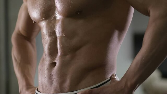 Closeup abs of a handsome man at gym