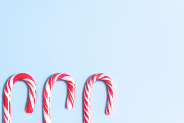Candy cane. Christmas. Christmas candy canes on a blue background. Christmas sweets and toys. New Year concept.