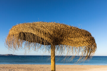Sombrilla de paja en playa  