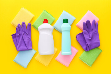 Colorful cleaning set for different surfaces in kitchen on yellow background. Top view, flat lay