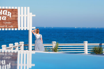 Girl on vacation by the pool with stunning sea views. Russia, Crimea,