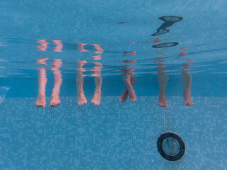 Feet of several people underwater
