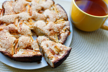 Apple pie on a plate and tea. Nice breakfast.