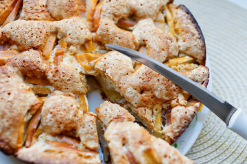 Knife and apple pie. Sliced charlotte cook.