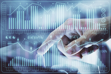 Multi exposure of man's hands holding and using a digital phone and forex graph drawing. Financial market concept.