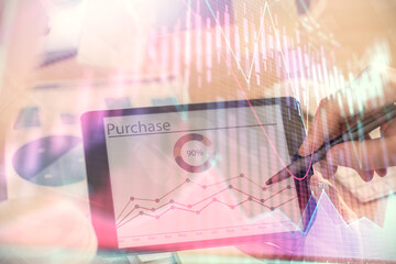 Double exposure of man's hands holding and using a phone and financial chart drawing. Market analysis concept.