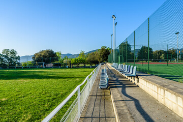 Local soccer field with empty seats.