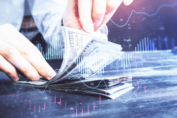 Multi exposure of forex graph drawing hologram and USA dollars bills and man hands. Technical...