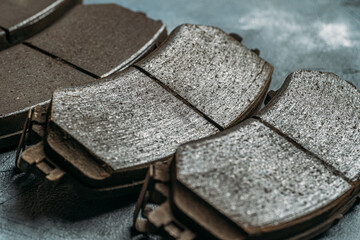 Used worn out car brake pads need to change, close up. - obrazy, fototapety, plakaty