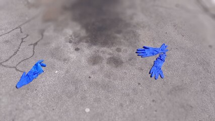 Used Blue Latex Gloves Litter Trash on Ground