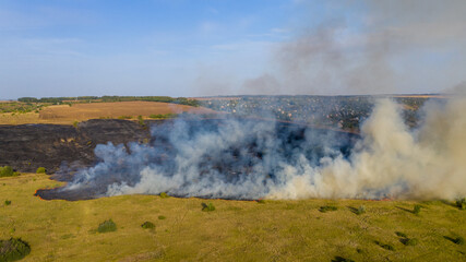 Forest fire aerial view, wildfire after dry summer season, burning nature.