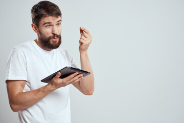 emotional man with tablet in hand touch screen new technologies light background cropped view Copy Space