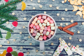 Cup of hot chocolate drink with marshmallows on a wooden background, Christmas decorations. A drink for the winter. Flat lay.