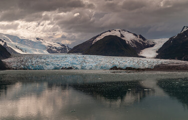 Amalia glacier melting end reflected in water in Sarmiento Channel, Chile.