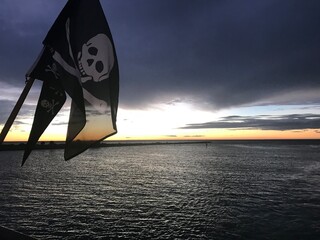 pirate flag at sunset over clearwater beach florida