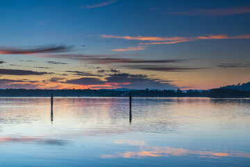 Clouds, reflections and sunrise over the bay