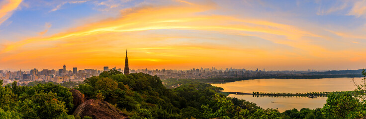 Ancient Baochu Pagoda.Chinese traditional architecture and modern city skyline in Hangzhou at sunrise,China.