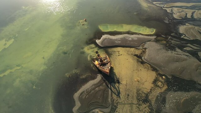 Scenic Aerial View Of The Skeleton Wreck Of FV Clyne Castle Steam Trawler In Breidamerkursandur, South Iceland - orbiting drone shot