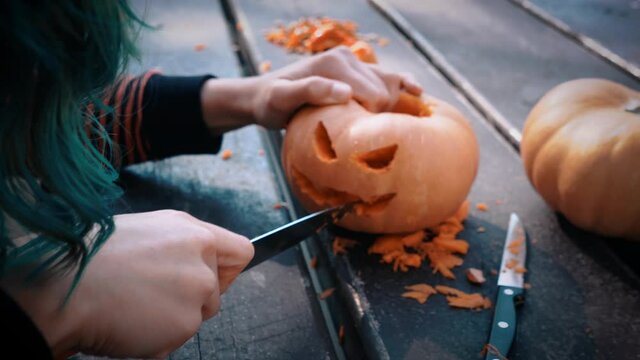 Finalizing the details for the holiday of Halloween with the cut of faces in the pumpkins