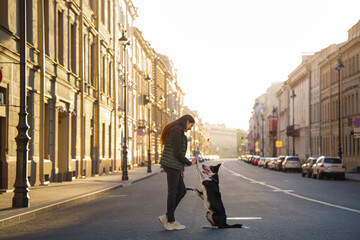 a girl and a dog on the background architecture St. Petersburg. Traveling with pet in the city