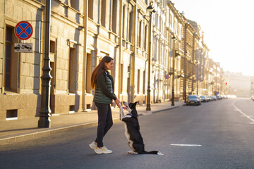 a girl and a dog on the background architecture St. Petersburg. Traveling with pet in the city