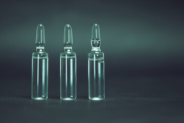 medical glass ampoules on a dark background.