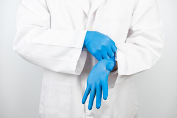 a doctor wearing blue latex gloves