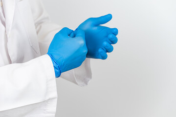 a doctor wearing blue latex gloves