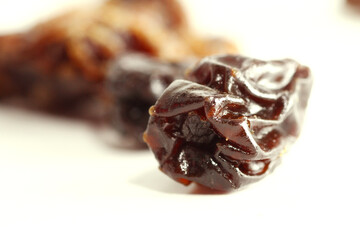 Macro of dehydrated grape fruit on white background