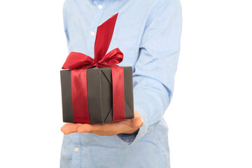 A man in a blue shirt gives you a gift
