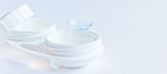 Soft contact lenses and white plastic case. Close up. Selective focus.