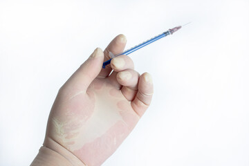 The hand holding the syringe.Isolated on a white background.