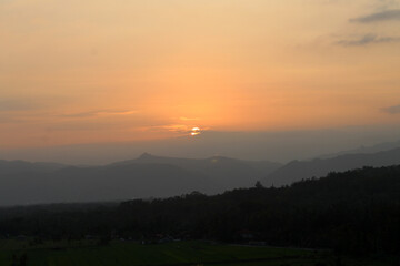 Sunset background. landscape view of sunset on mountain.