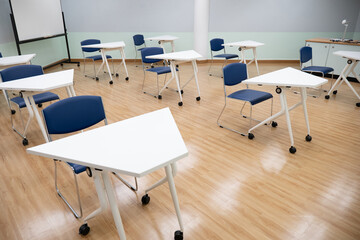 Fototapeta na wymiar Interior empty classroom in university, Concept of back to school, setting of chair in the room design social distancing