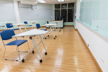 Fototapeta na wymiar Interior empty classroom in university, Concept of back to school, setting of chair in the room design social distancing