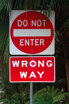 Close-up view of a red and white double traffic sign DO NOT ENTER and WRONG WAY