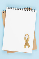 gold ribbon on open notebook