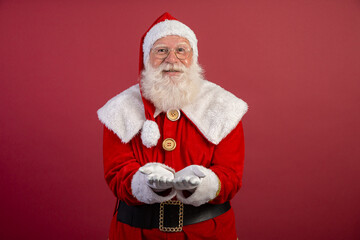 Santa Claus on red background with copy space. Presenting.