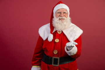 Santa Claus on red background with copy space. Presenting.