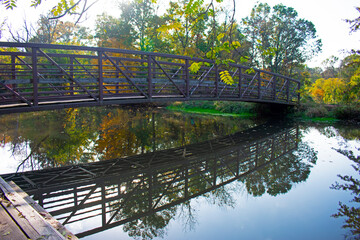 Steel pedestrian footbridge with wooden walkway crossing a narrow section of the Delaware and...